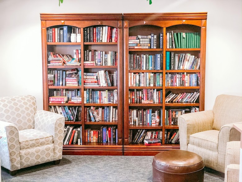 Bright, welcoming library with comfortable seating and extensive book collection